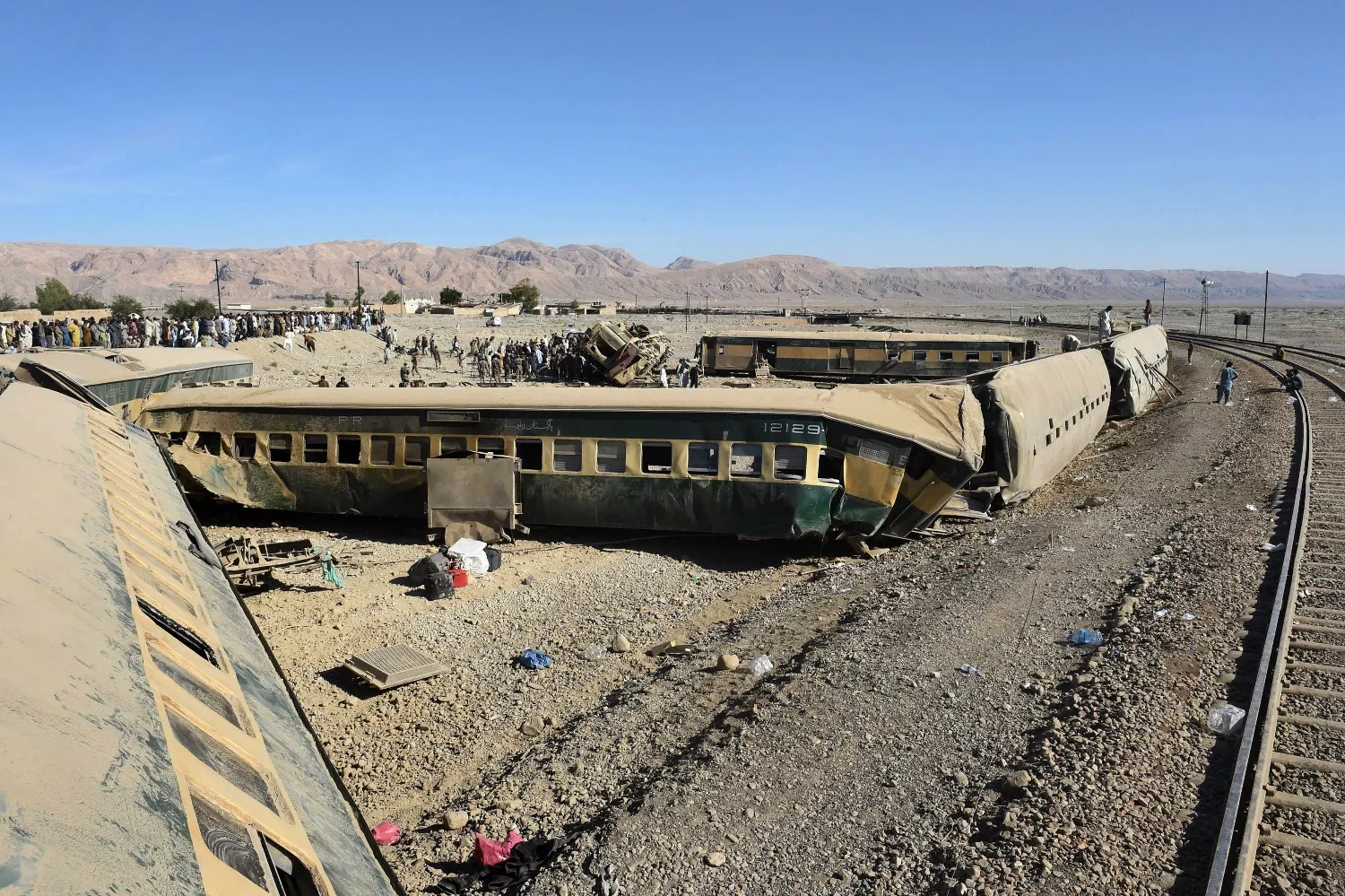 security officials inspect damaged carriages following the derailment of a passenger train in bolan district some 75 kilometres from quetta on november 17 2015 photo afp security officials inspect damaged carriages following the derailment of a passenger train in bolan district some 75 kilometres from quetta on november 17 2015 photo afp