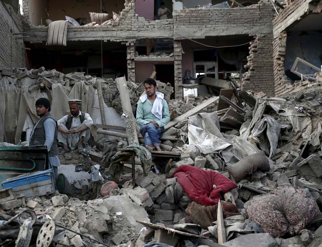 men sit amid debris of their properties at the site a truck bomb blast in kabul august 7 2015 photo reuters