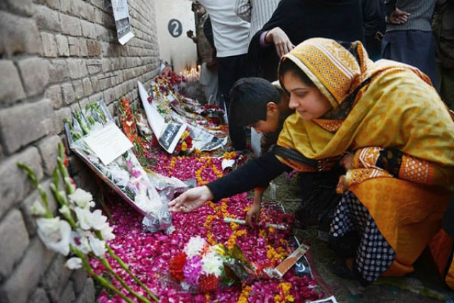 file photo of people paying respects to aps victims photo afp file photo of people paying respects to aps victims photo afp