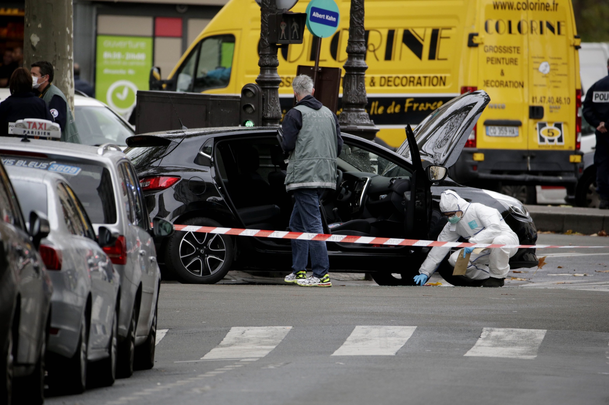 police officers carry out investigations on a car in the 18th district of paris on november 17 2015 which is suspected to have been involved in the november 13 2015 terror attacks in which at least 129 people were killed photo afp