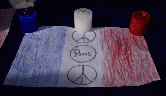 red white and blue candles are displayed with a drawing of the french flag during a remembrance service in civic square wellington on november 17 2015 photo afp red white and blue candles are displayed with a drawing of the french flag during a remembrance service in civic square wellington on november 17 2015 photo afp