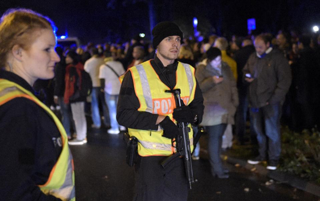 police secure the area as supporters leave the stadium after a friendly football match is called off in barsinghausen on november 17 2015 photo afp