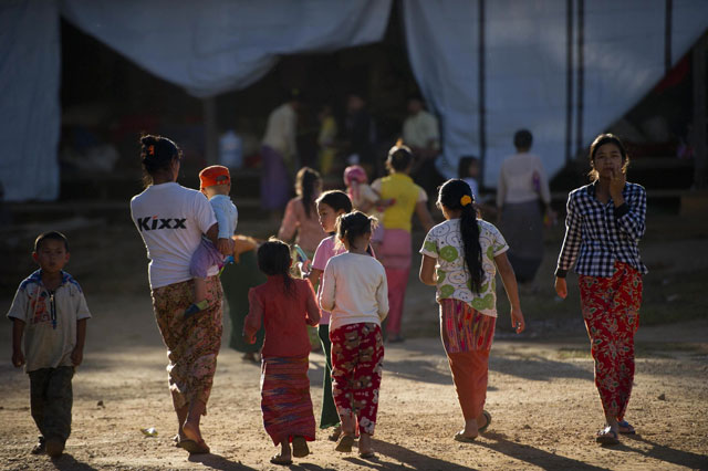 in this photograph taken on november 17 2015 residents of minenaung who fled the fighting between myanmar government troops and shan ethnic army groups walk around in a temporary evacuation center in a buddhist monastery located in laihka 148 km away from taunggyi city of southern shan state in shan state myanmar photo afp