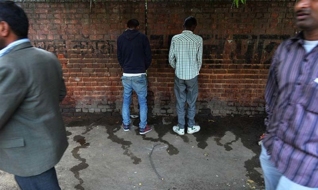 indian men urinate on a wall at a roadside in new delhi photo afp indian men urinate on a wall at a roadside in new delhi photo afp