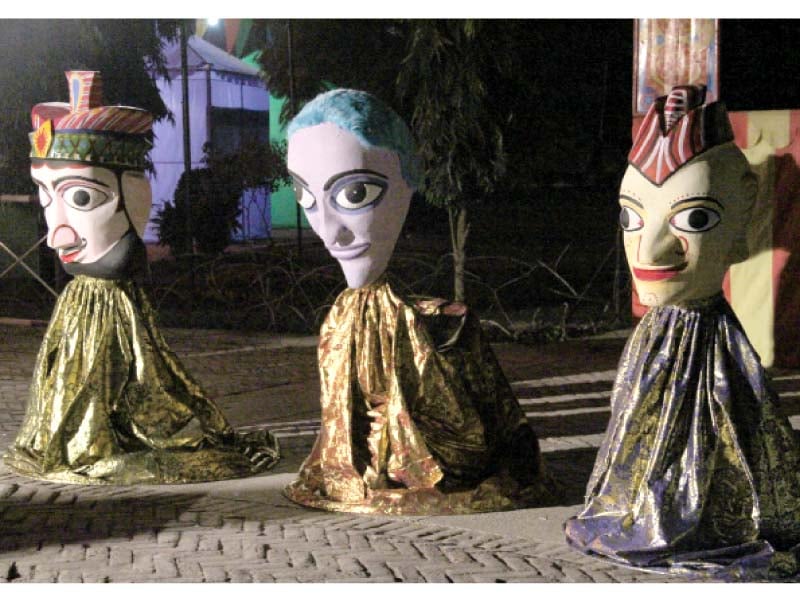 puppets at the festival s venue left the decorated entrance of alhamra cultural complex right photos ayesha mir express