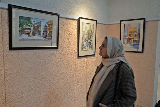 isitors appreciate shabbier s work at the exhibition photo muhammad iqbal express