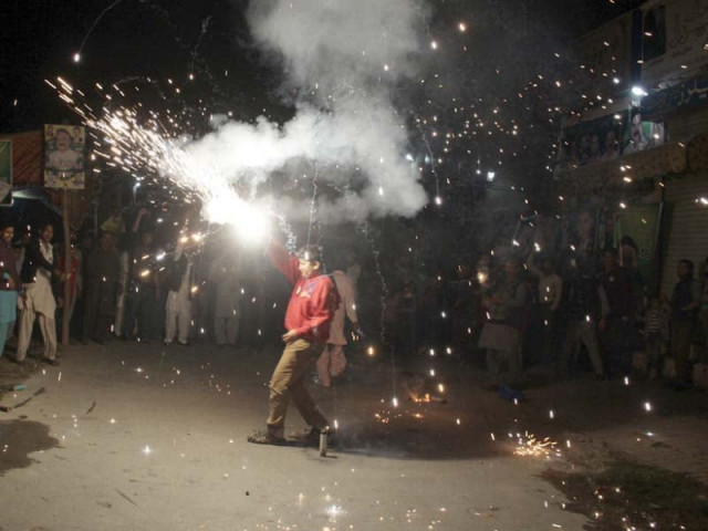 a pml n supporter sets off firecrackers in gujranwala photo express a pml n supporter sets off firecrackers in gujranwala photo express