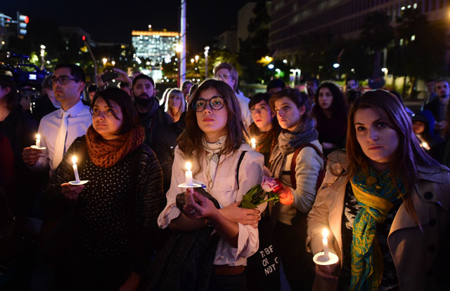 people hold candles in los angeles on november 17 2015 where mayor eric garcetti was joined by french consul general christophe lemoine and a gathered crowd for a memorial service in memory of the victims of last friday 039 s attacks in paris photo afp