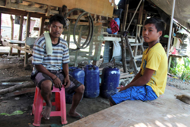 meljie potaso 16 and his father melecio sit outside their house in san antonio village near basey on samar island in the philippines on october 12 2015 photo reuters