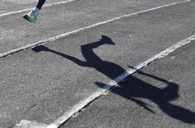 an athlete casts a shadow on a race track while training at a local stadium in the southern city of stavropol russia on november 10 2015 photo reuters