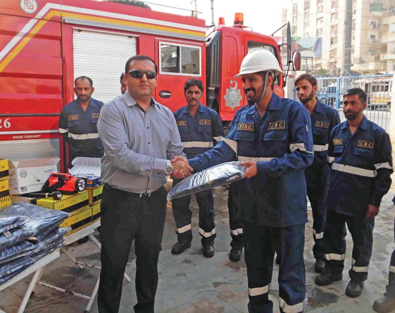 executive officer shahrome safdar khattak distributes latest fire proof equipment and uniform among the firefighters of cantonment board clifton photo press release