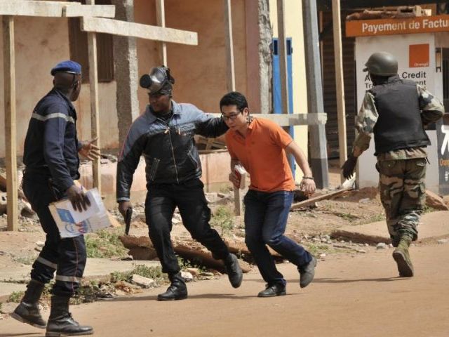 malian security forces evacuate a man from near the radisson blu hotel in bamako on november 20 2015 photo afp