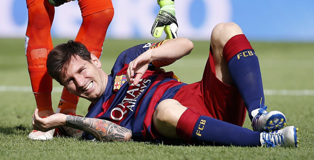 file photo of barcelona 039 s lionel messi as he lies on the pitch after injuring his left knee during their match against las palmas at camp nou stadium in barcelona spain photo reuters