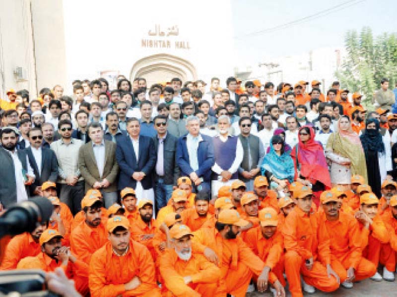 officials pose with wssp and volunteers after a hard day of cleaning the city photo express