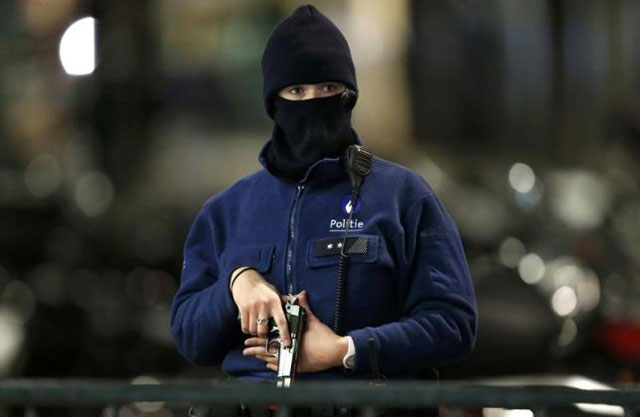 a belgian police officer searches the area during a continued high level of security following the recent deadly paris attacks in brussels belgium on november 22 2015 photo reuters