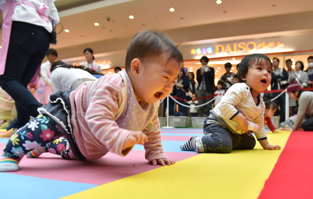 babies compete in a baby crawling competition hosted by a japanese magazine that specializes in pregnancy childbirth and child rearing in yokohama kanagawa prefecture on november 23 2015 photo afp