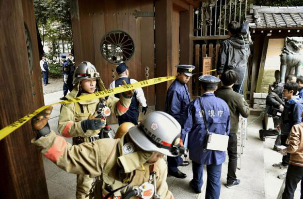 police officers and fire fighters investigate at the south gate of japan 039 s controversial yasukuni shrine where there was an explosion and burned the ceiling and wall of the public bathroom in tokyo japan in this photo taken by kyodo november 23 2015 photo reuters