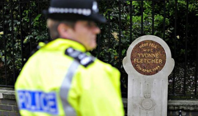 a british police officer stands near the memorial stone to pc yvonne fletcher before a ceremony to mark the 25th anniversary of her death in st james square in london on on april 17 2009 photo afp file