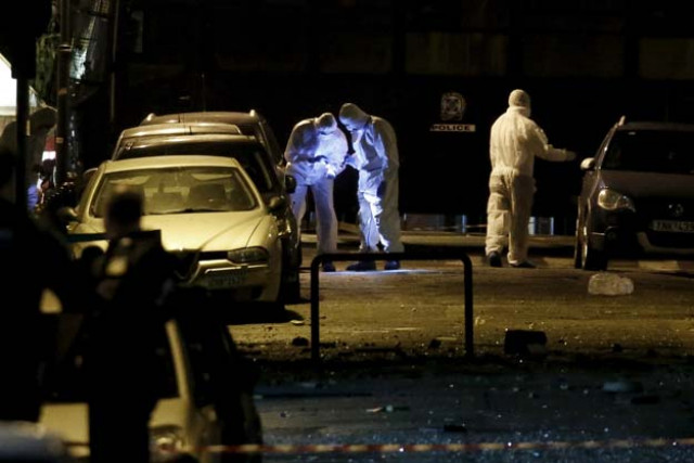 forensic experts search for evidence on a street where a bomb exploded outside the entrance of the hellenic business federation offices in athens greece november 24 2015 a bomb exploded outside the offices of a greek business federation in central athens early on tuesday police officials said smashing windows but causing no injuries photo reuters forensic experts search for evidence on a street where a bomb exploded outside the entrance of the hellenic business federation offices in athens greece november 24 2015 a bomb exploded outside the offices of a greek business federation in central athens early on tuesday police officials said smashing windows but causing no injuries photo reuters