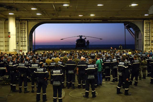 french navy soldiers wait for the arrival of french army chief of staff general pierre de villiers aboard the french charles de gaulle aircraft carrier on november 23 2015 at the eastern mediterranean sea as part of operation chammal in syria and iraq against the islamic state france launched air strikes against islamic state group targets in iraq on november 23 in the first sorties from the charles de gaulle aircraft carrier newly deployed in the eastern mediterranean photo afp