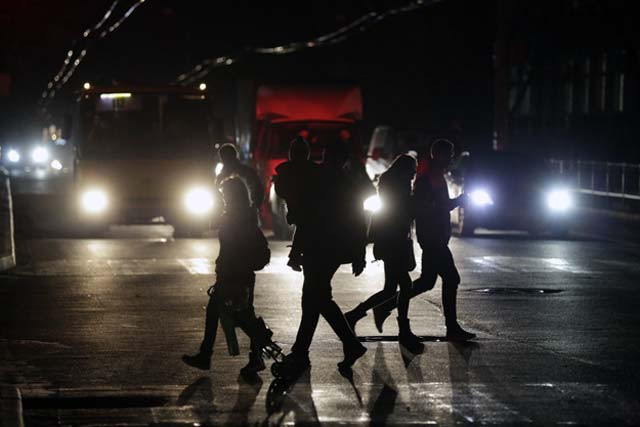 people cross a road during a power outage in the crimean city of simferopol on november 24 2015 power cuts in crimea affected nearly 940 000 people on november 24 as tensions raged between kiev and moscow over the annexed peninsula and russia threatened to cut off gas supplies to ukraine photo afp people cross a road during a power outage in the crimean city of simferopol on november 24 2015 power cuts in crimea affected nearly 940 000 people on november 24 as tensions raged between kiev and moscow over the annexed peninsula and russia threatened to cut off gas supplies to ukraine photo afp