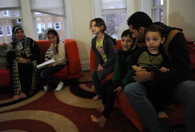 syrian refugees safa mshymish l and ismil alrife 2r sit with their children rama 2l noor c malath 3r and ameer r in their apartment in chicago illinois on november 20 2015 photo afp