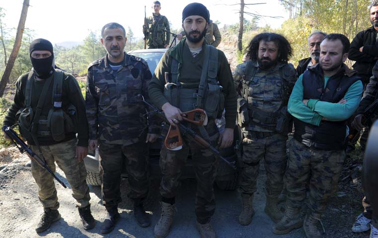 alpaslan celik a deputy commander in a syrian turkmen brigade c holds handles believed to be parts of a parachute of the downed russian warplane near the northern syrian village of yamadi near the turkish syrian border syria november 24 2015 photo reuters