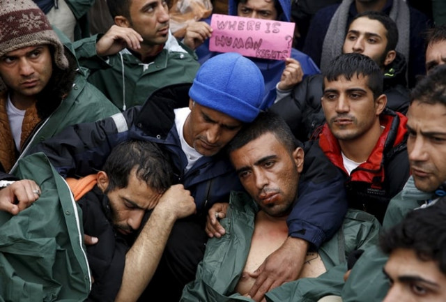 stranded iranian migrants on hunger strike some with their lips sewn together sit on rail tracks at the borderline between greece and macedonia near the greek village of idomeni on november 25 2015 photo reuters stranded iranian migrants on hunger strike some with their lips sewn together sit on rail tracks at the borderline between greece and macedonia near the greek village of idomeni on november 25 2015 photo reuters