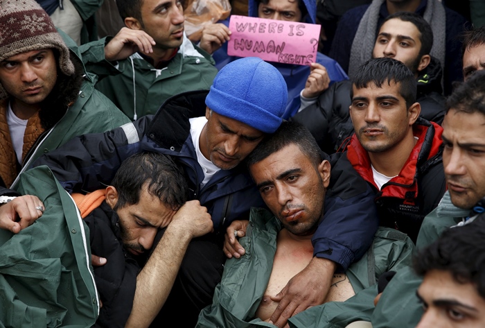 stranded iranian migrants on hunger strike some with their lips sewn together sit on rail tracks at the borderline between greece and macedonia near the greek village of idomeni on november 25 2015 photo reuters