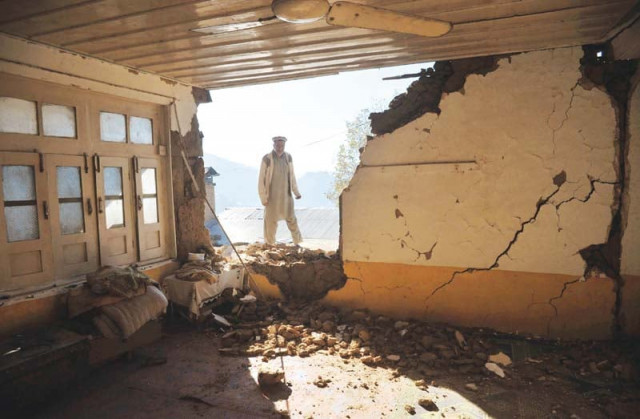 a man looks at a damaged house in earthquake hit lower dir photo afp a man looks at a damaged house in earthquake hit lower dir photo afp
