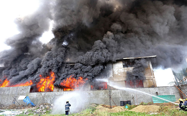 philippine firemen try to put out a fire after it gutted a footwear factory in manila in may 2015 photo reuters