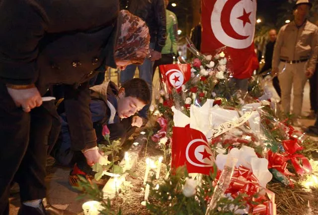 tunisians light candles during a vigil on november 25 2015 at the site of the attack on a bus in central tunis which killed several presidential guards the previous day the islamic state group claimed the deadly bombing of a presidential guard bus in the tunisian capital in a statement shared on jihadist social media accounts photo afp tunisians light candles during a vigil on november 25 2015 at the site of the attack on a bus in central tunis which killed several presidential guards the previous day the islamic state group claimed the deadly bombing of a presidential guard bus in the tunisian capital in a statement shared on jihadist social media accounts photo afp