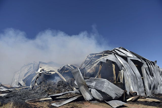 smoke rises from a burning godown used for dry fodder following bushfires in freeling north of adelaide on november 26 2015 photo afp smoke rises from a burning godown used for dry fodder following bushfires in freeling north of adelaide on november 26 2015 photo afp