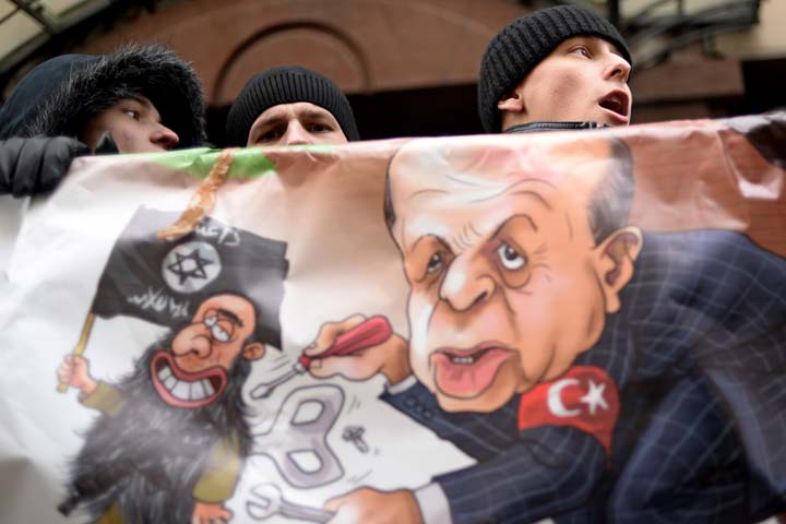 protesters hold a placard and shout slogans in front of the turkish embassy in moscow on november 25 2015 photo afp