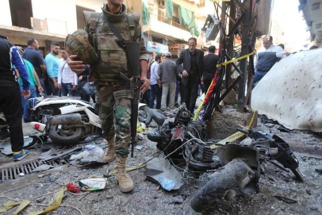 a lebanese army soldier walks past damaged motorbikes at the site of the two explosions that occurred on thursday in the southern suburbs of the lebanese capital beirut november 13 2015 photo reuters