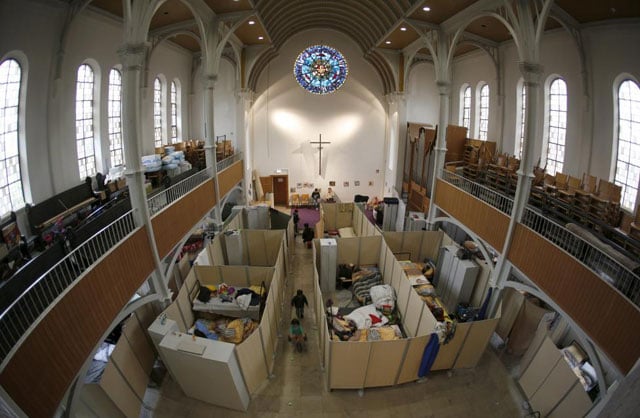 beds for migrants separated by impromptu partition screens are set up inside a protestant church in oberhausen germany october 30 2015 photo reuters