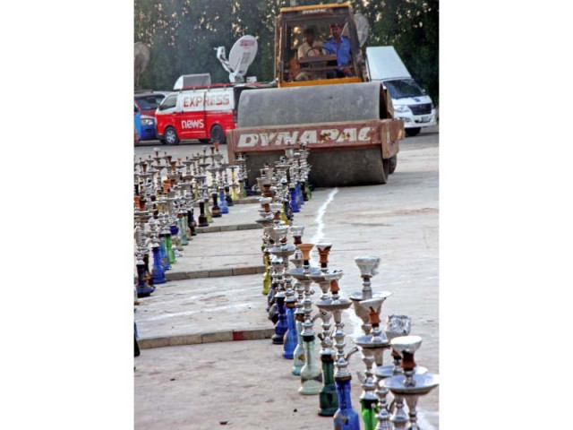 more than 800 hookahs collected by dha authorities during the last two month from cafes and parlours in zamzama khadda market and other areas were crushed and their flavoured tobacco was set on fire photo athar khan express more than 800 hookahs collected by dha authorities during the last two month from cafes and parlours in zamzama khadda market and other areas were crushed and their flavoured tobacco was set on fire photo athar khan express