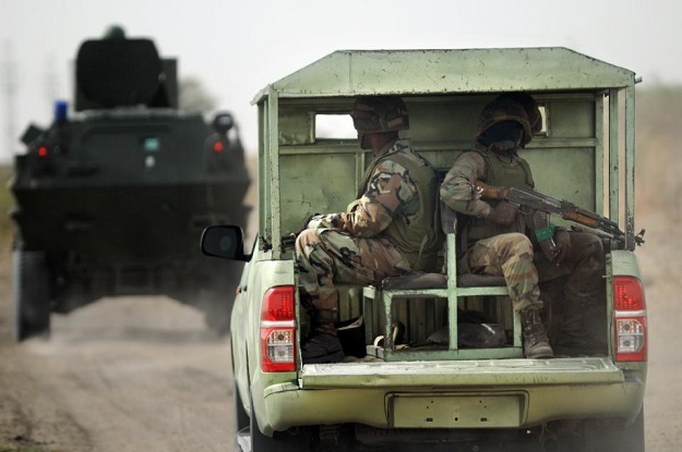 nigerian soldiers patrol in the north of borno state close to a former boko haram camp on june 5 2013 near maiduguri photo afp