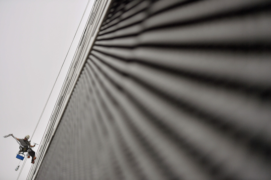 A worker cleans the windows of a building in Nantes. PHOTO: AFP