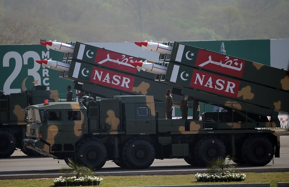 Military personnel stand beside short-range Surface to Surface Missile NASR during a Pakistan Day military parade in Islamabad. PHOTO: AFP