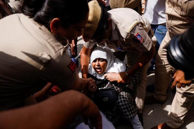 police detain a supporter of the aam aadmi party aap during a protest in new delhi india march 26 2024 photo reuters police detain a supporter of the aam aadmi party aap during a protest in new delhi india march 26 2024 photo reuters