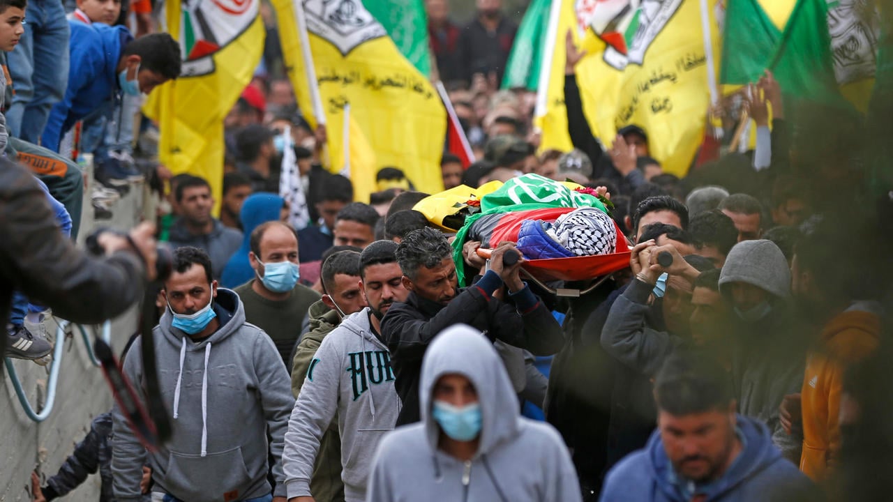 mourners carry the body of palestinian teenager ali abu aliya during his funeral in the village of mughayir near ramallah a day after he was killed in clashes with the army during a protest against jewish settlements photo afp