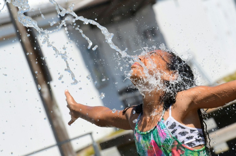 a child cools off at a community water park on a scorching hot day in richmond british columbia photo afp