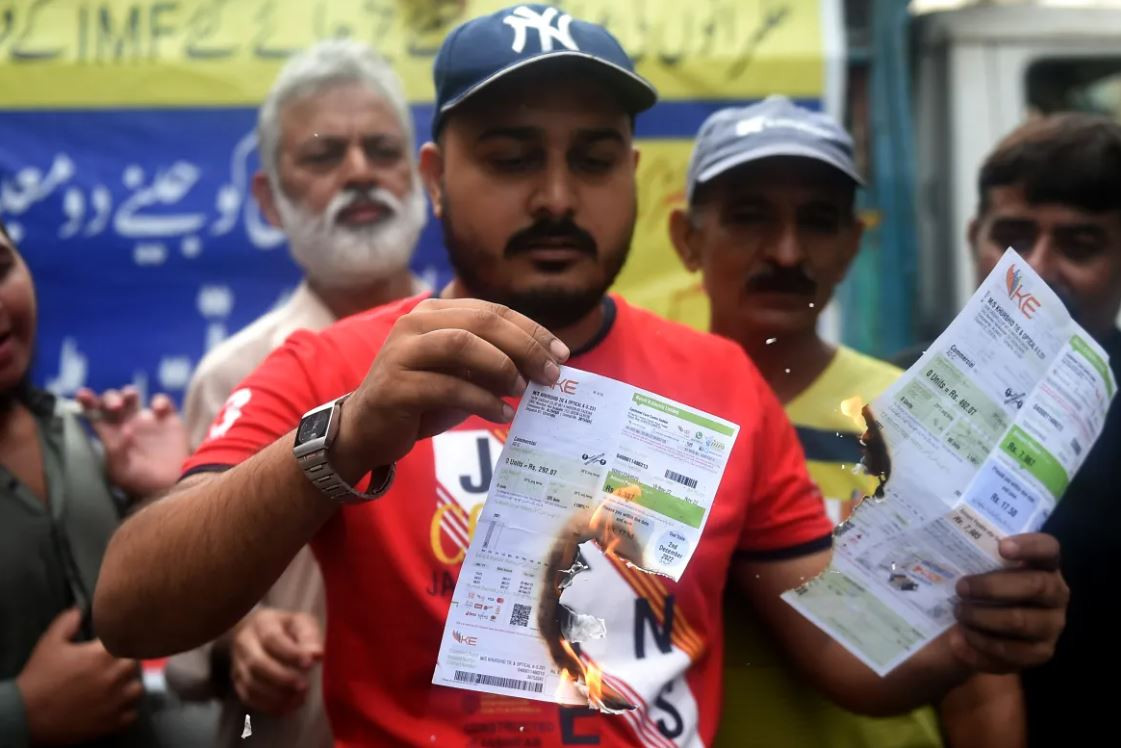 a trader sets electricity bills on fire during a protest against the surge in petrol and electricity prices in karachi photo afp