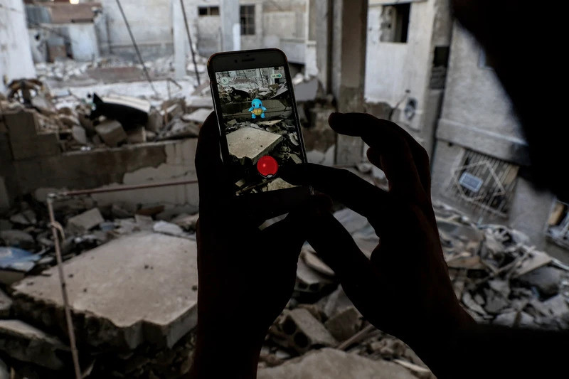 On July 23, 2016, a Syrian gamer used the Pokémon Go app on his phone to catch a Pokémon amidst the ruins of Douma, a besieged rebel-held town located east of Damascus. AFP