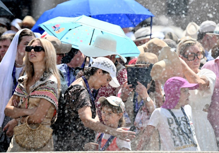 people cooled off in fountains in st peter s square in rome photo afp
