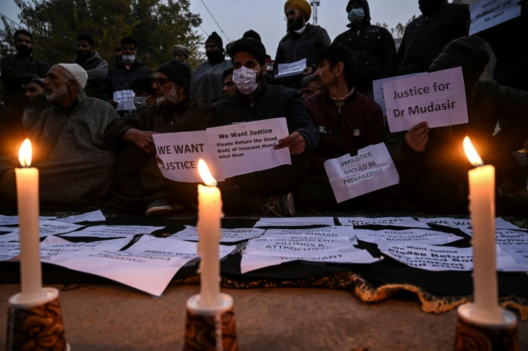 family of the two dead men staged a candlelight vigil in srinagar demanding their bodies be returned for a proper islamic burial photo afp