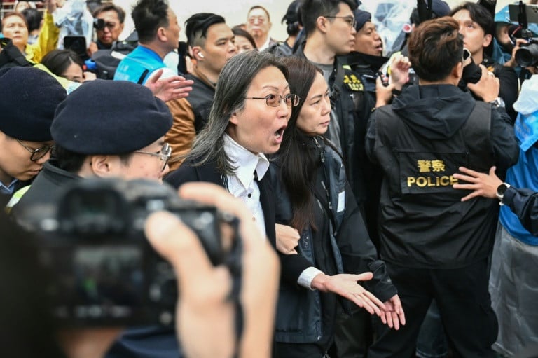 police detain a woman outside the court in hong kong on november 19 2024 photo afp