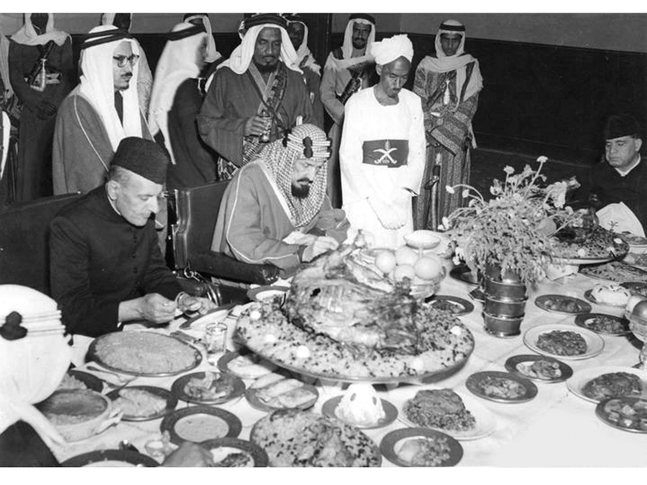 Dr. Hakim (right) at a banquet hosted by King Ibne Saud of Saudi Arabia where he was presented with a royal robe and sword in 1953. Seated on the left is Governor General of Pakistan Ghulam Muhammad, and standing behind in glasses is Muhammad Asad the Austro-Hungarian-born Jew who converted to Islam and translated the Quran into English
