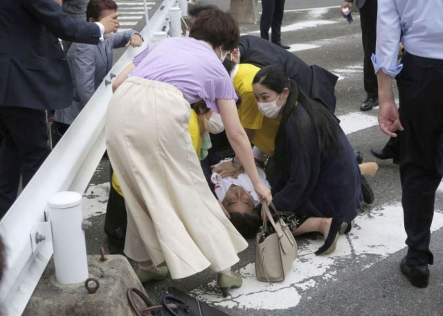 former japanese prime minister shinzo abe lies on the ground after apparent shooting during an election campaign for the july 10 2022 upper house election in nara western japan july 8 2022 in this photo taken by kyodo mandatory credit kyodo via reuters former japanese prime minister shinzo abe lies on the ground after apparent shooting during an election campaign for the july 10 2022 upper house election in nara western japan july 8 2022 in this photo taken by kyodo mandatory credit kyodo via reuters
